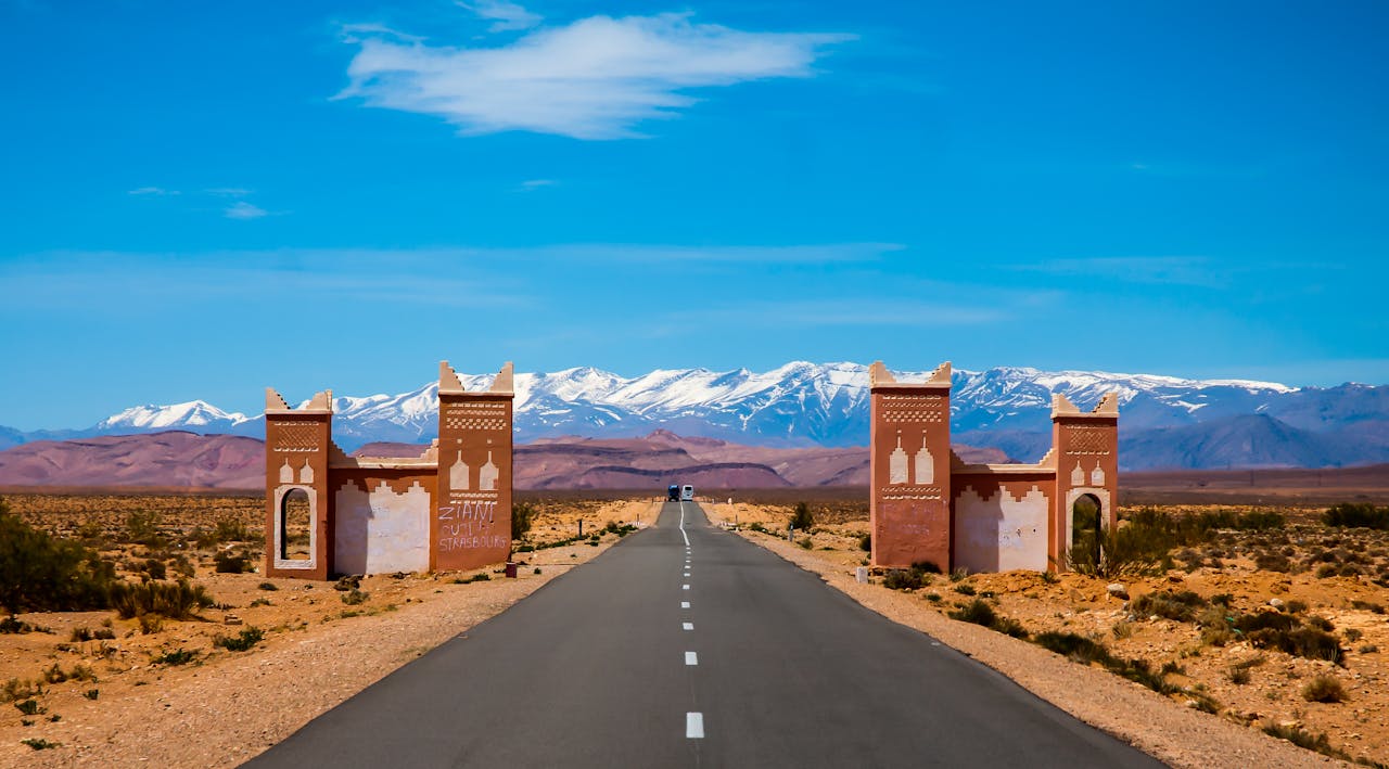 Explore the open road leading to Morocco's Atlas Mountains on a sunny day.