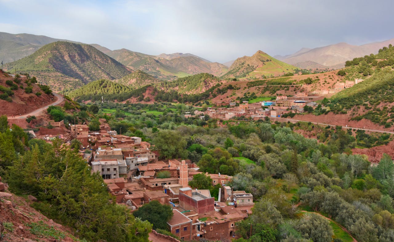 Scenic aerial view of Ait Barka village amidst lush green valleys and rugged mountains.