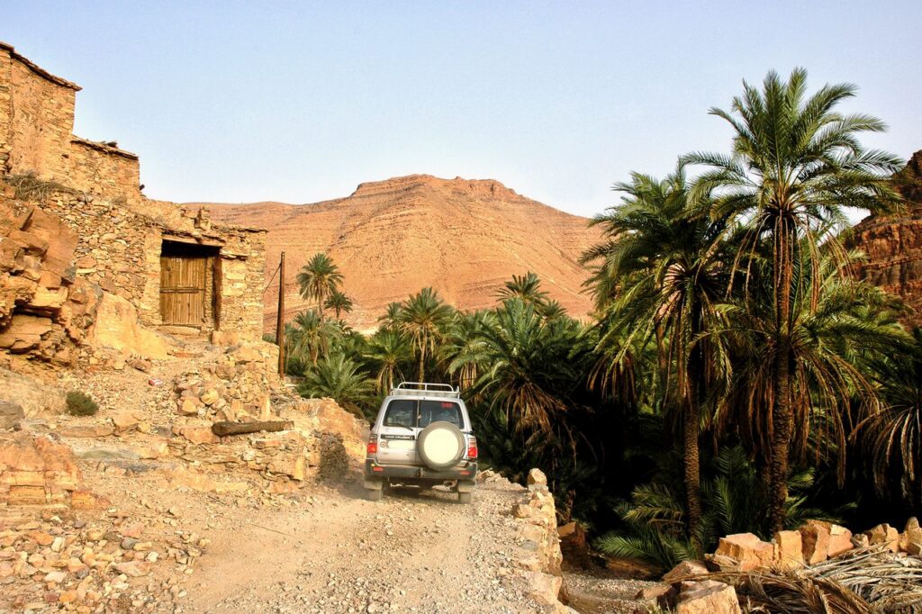 Explore Tamanarte village with an off-road vehicle amidst stunning desert landscapes and lush palm oasis.